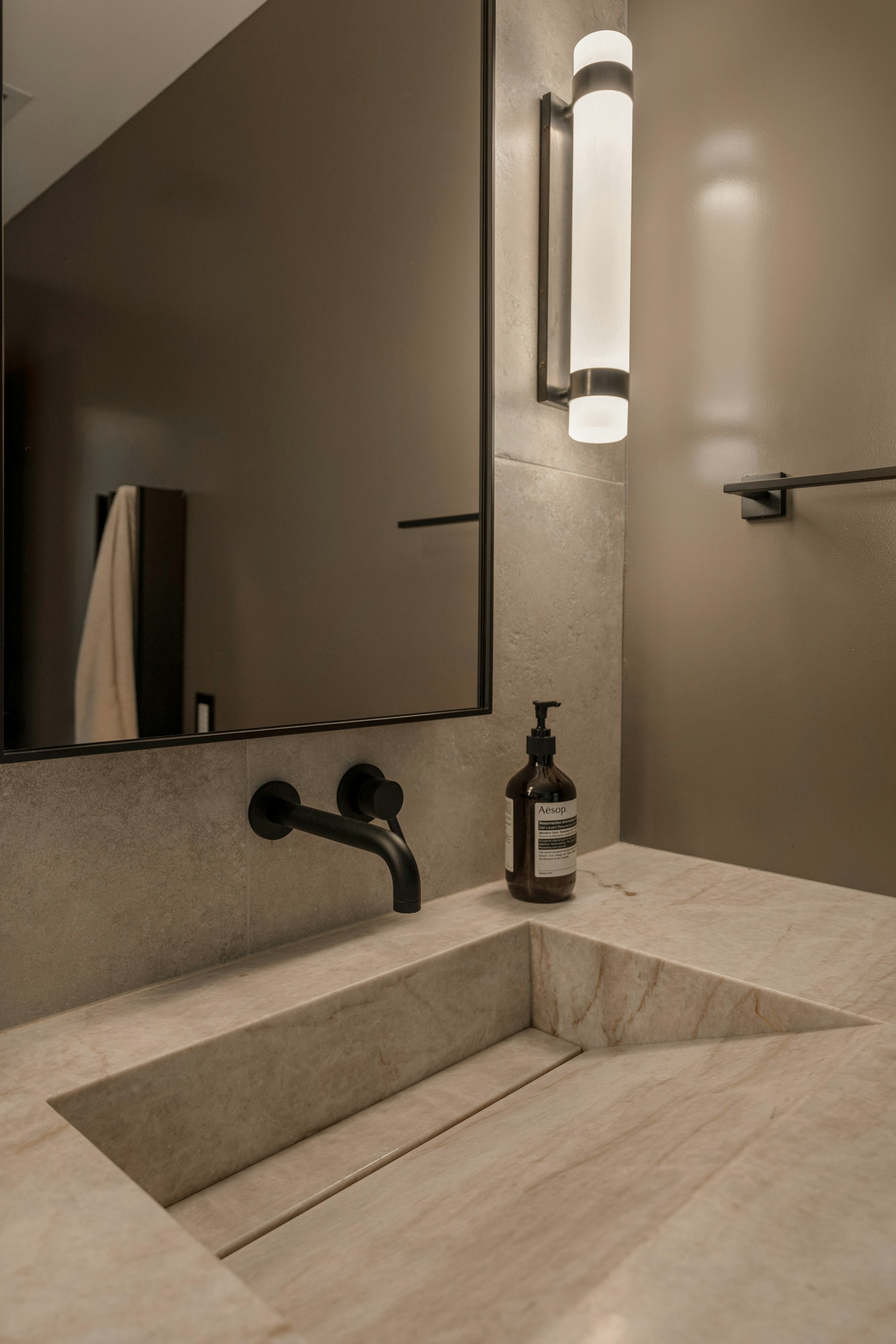 Stone basin and black tapware detail